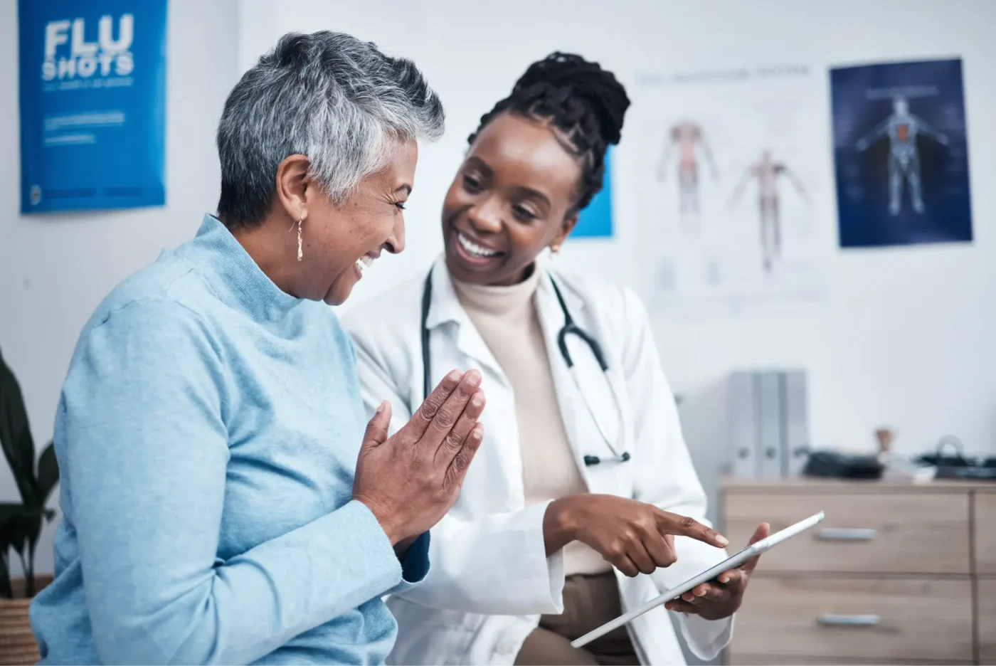 Doctor and patient talking and looking at a tablet