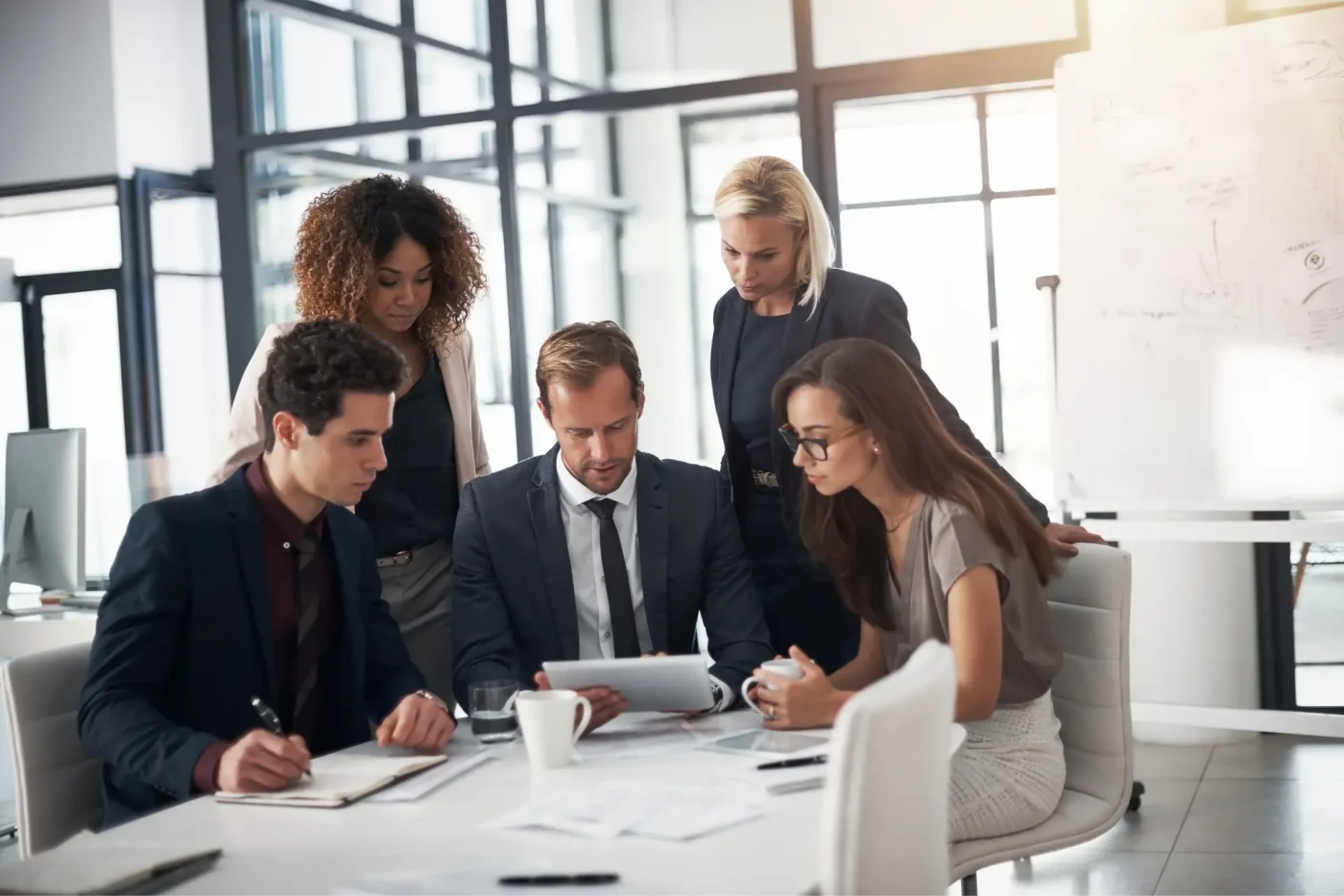 Business people meeting and looking at a tablet