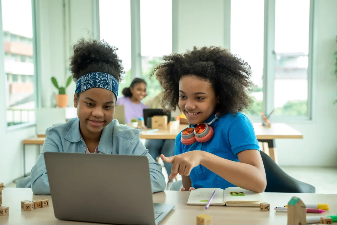 Children watching a video lesson on a laptop