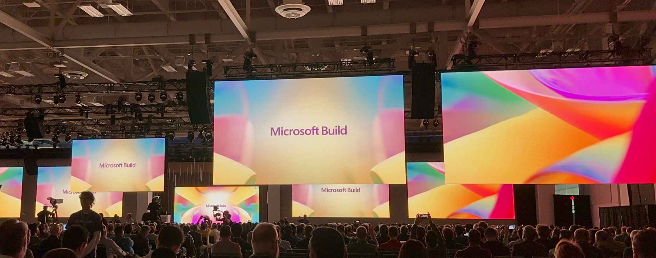 Build's conference room with multiple screens displaying Microsoft Build.