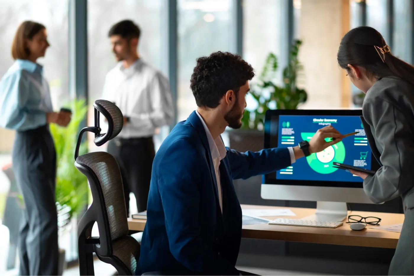 People analyzing financial graphs on a monitor