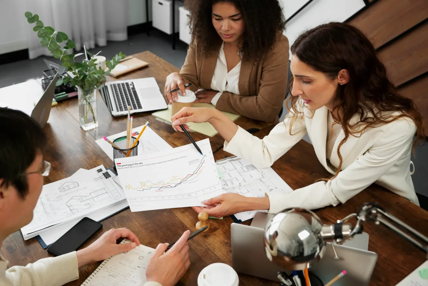 People reviewing graphs at an office table