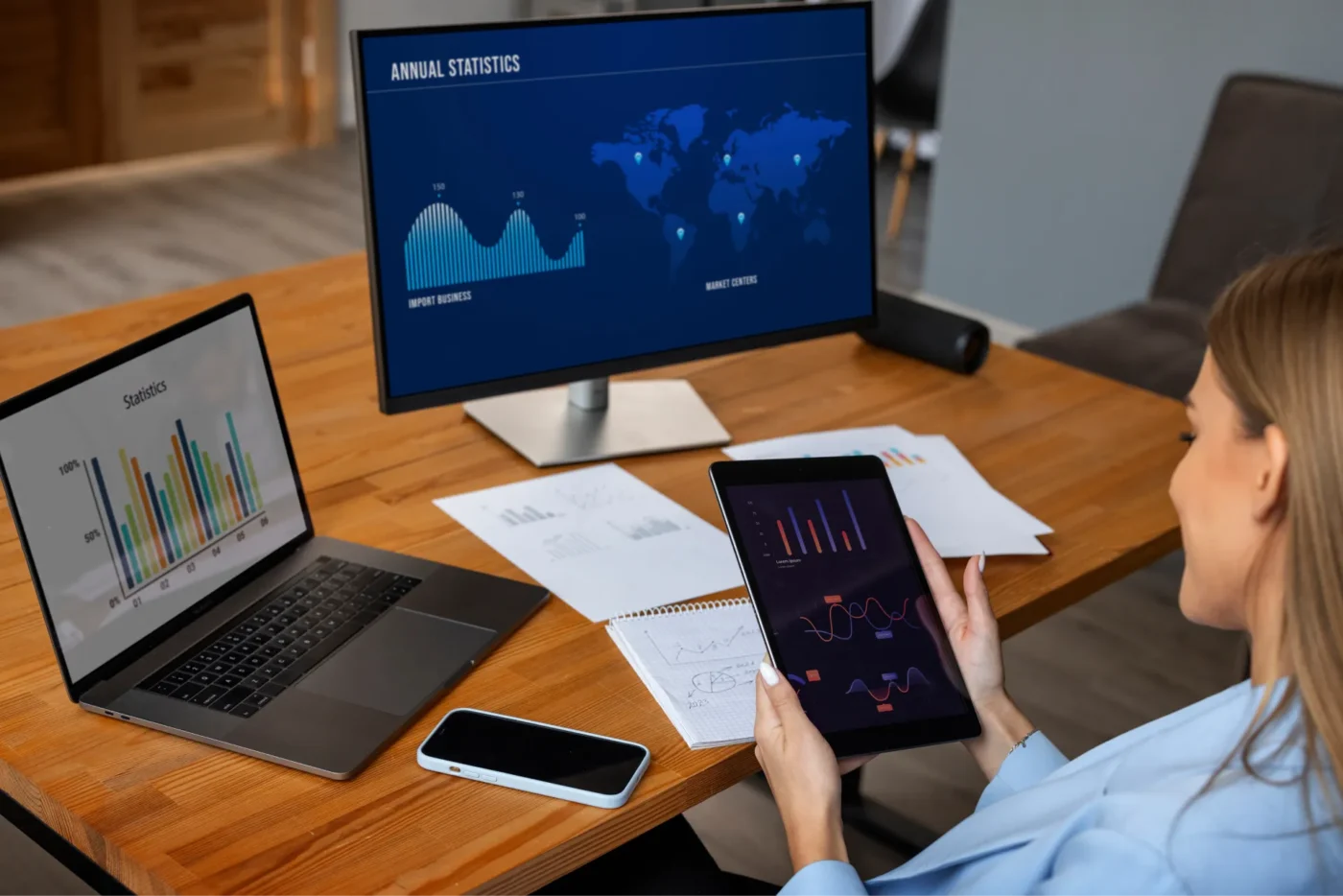 Person looking at financial graphs on monitors