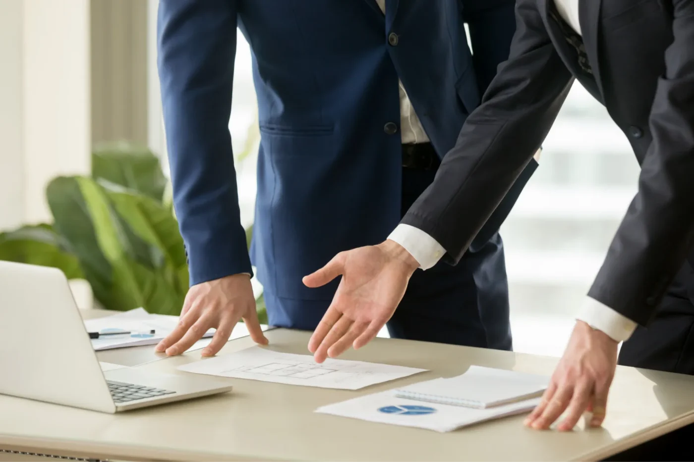 People reviewing documents that are laid out on a table